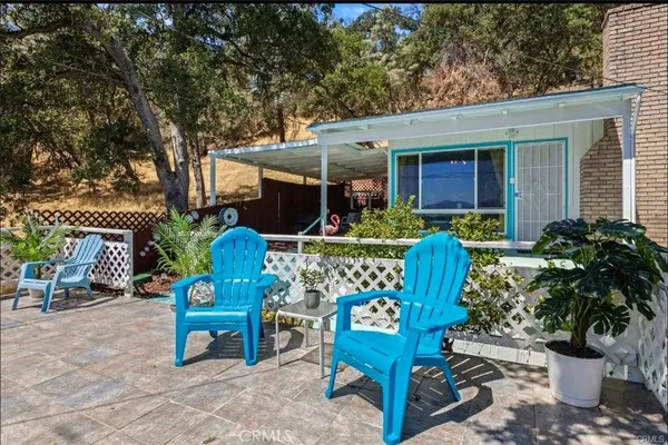a view of a chairs and tables in the patio in front of a house