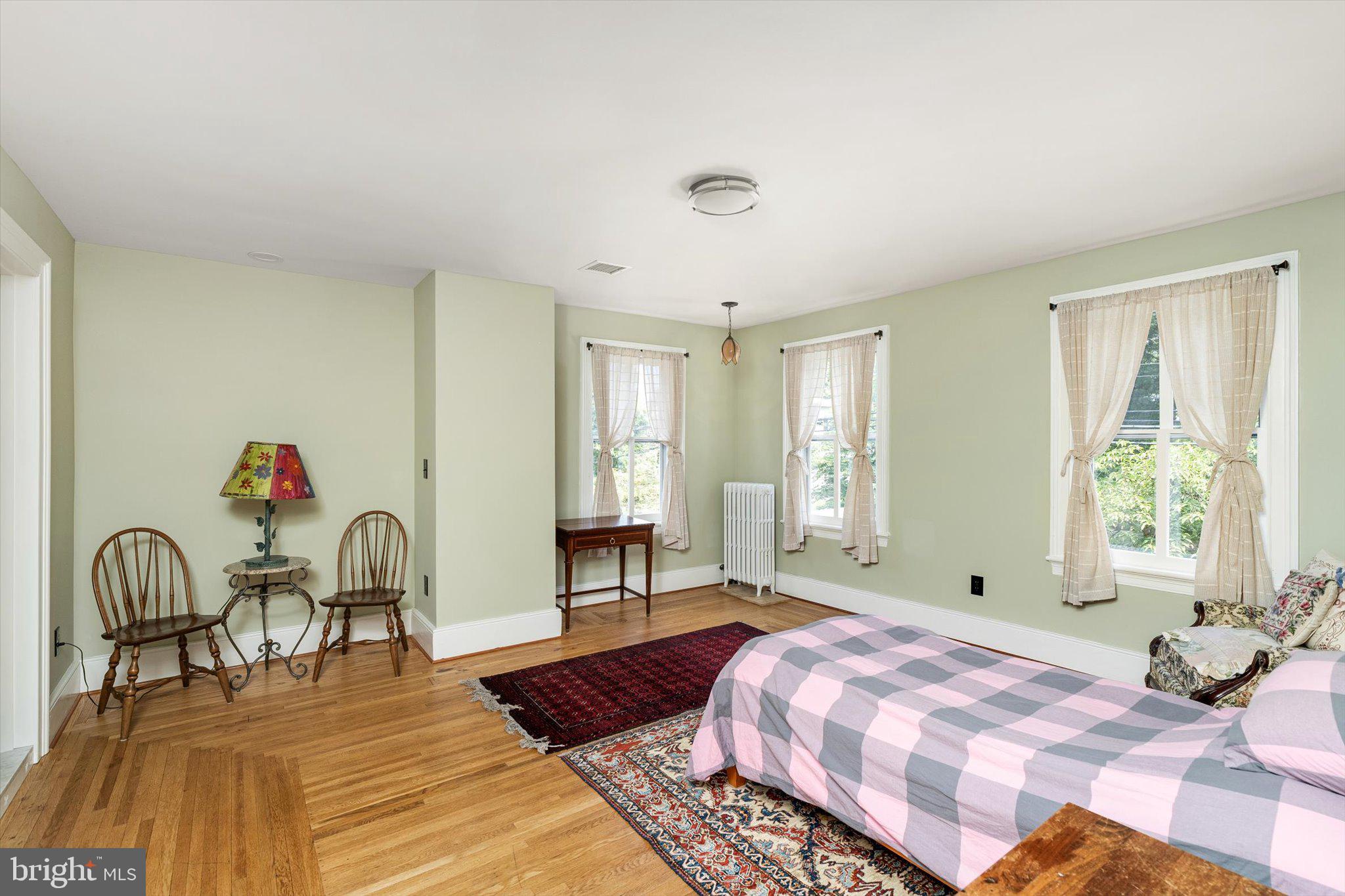 302 South Main Street Hightstown, NJ 08520 - Photo 14 of 39 a spacious bedroom with a bed and a table in it