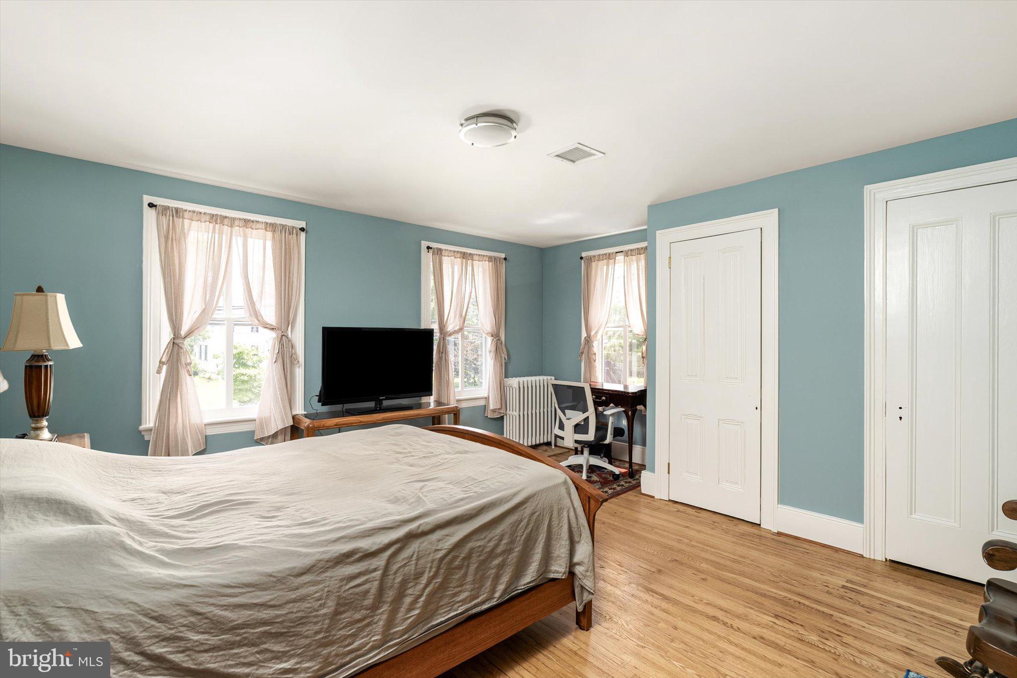 302 South Main Street Hightstown, NJ 08520 - Photo 17 of 39 a bedroom with a bed and wooden floor