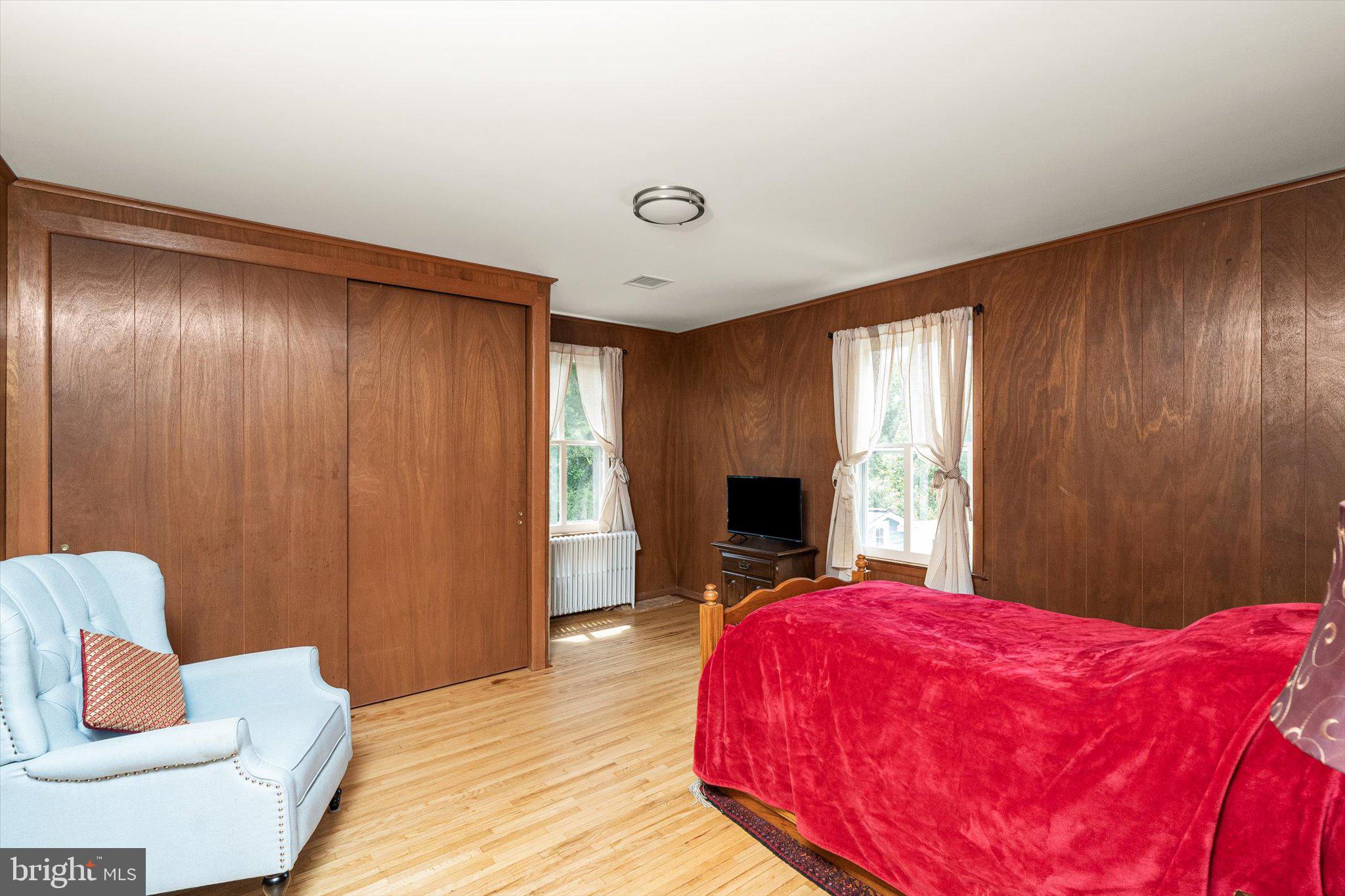 302 South Main Street Hightstown, NJ 08520 - Photo 19 of 39 a bed room with a bed and a chair