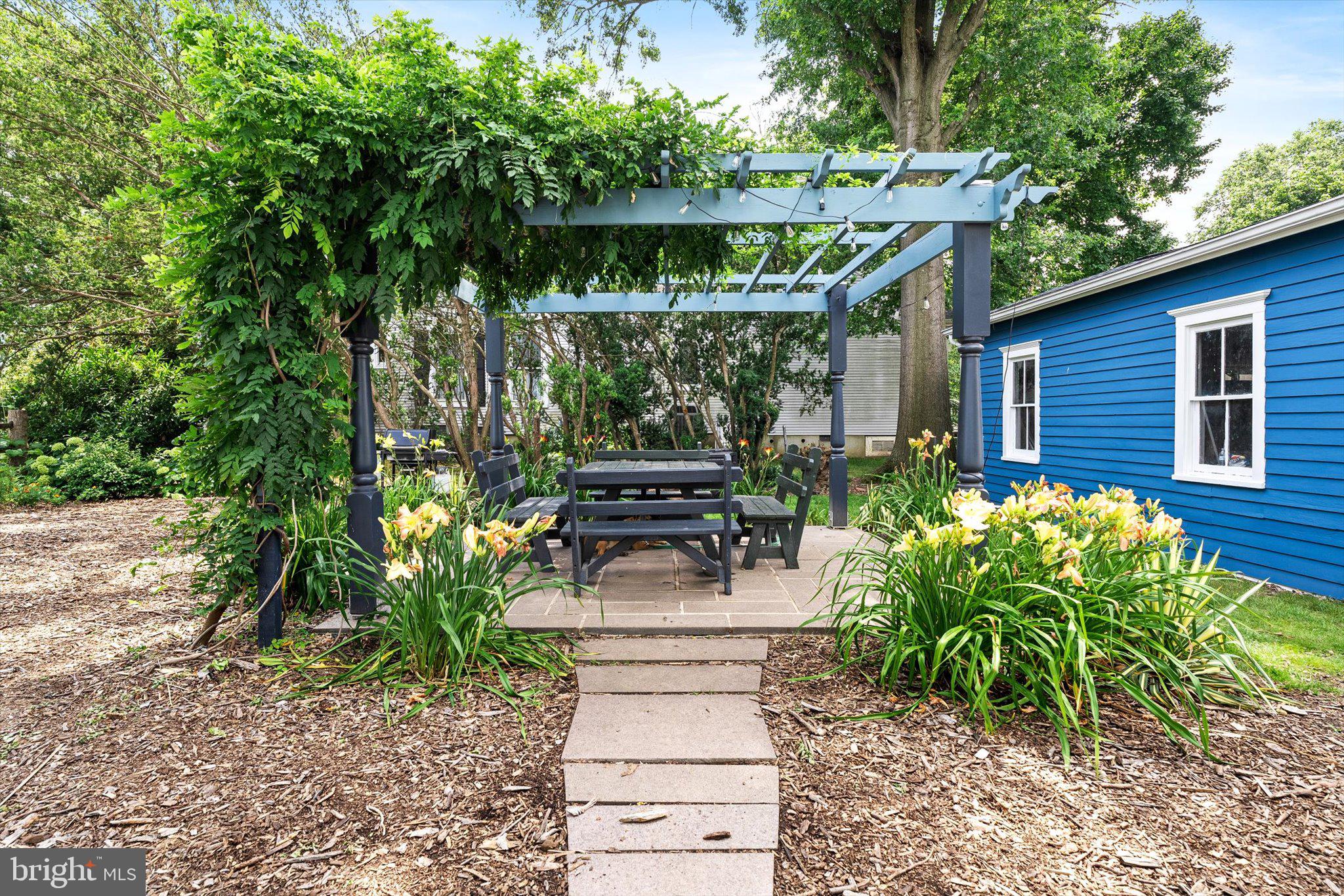302 South Main Street Hightstown, NJ 08520 - Photo 27 of 39 a view of a patio with table and chairs potted plants and large tree