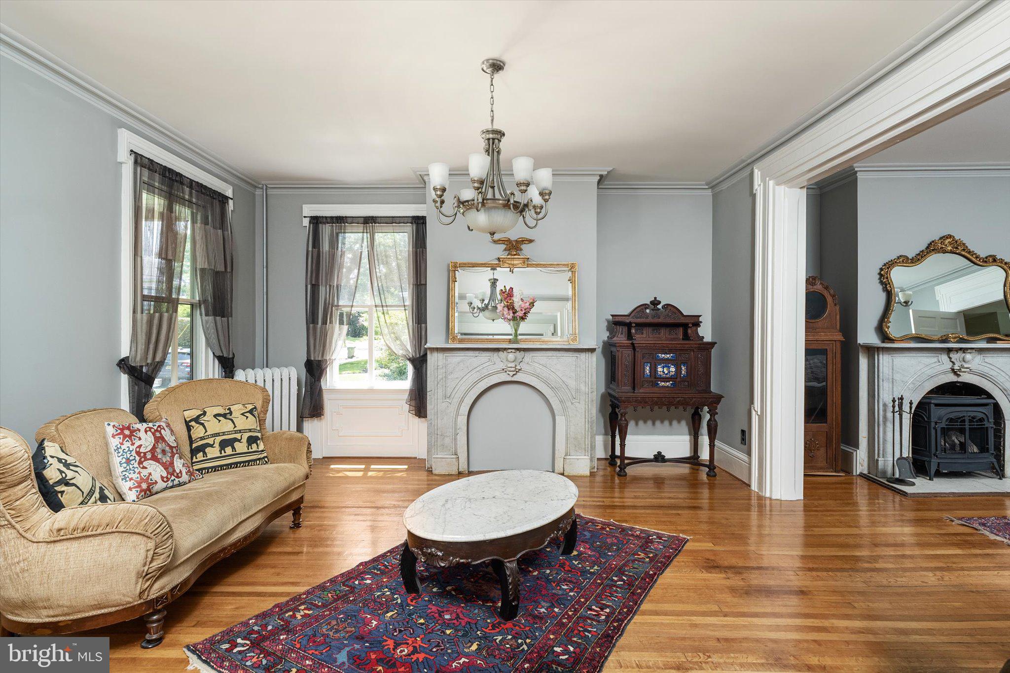 302 South Main Street Hightstown, NJ 08520 - Photo 7 of 39 a living room with furniture a fireplace and a chandelier