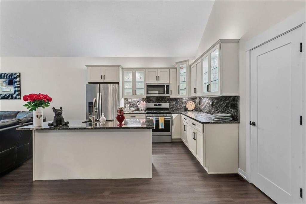 113 Hemingway Lane Coraopolis, PA 15108 - Photo 12 of 44 a kitchen with stainless steel appliances granite countertop a stove a sink and a refrigerator