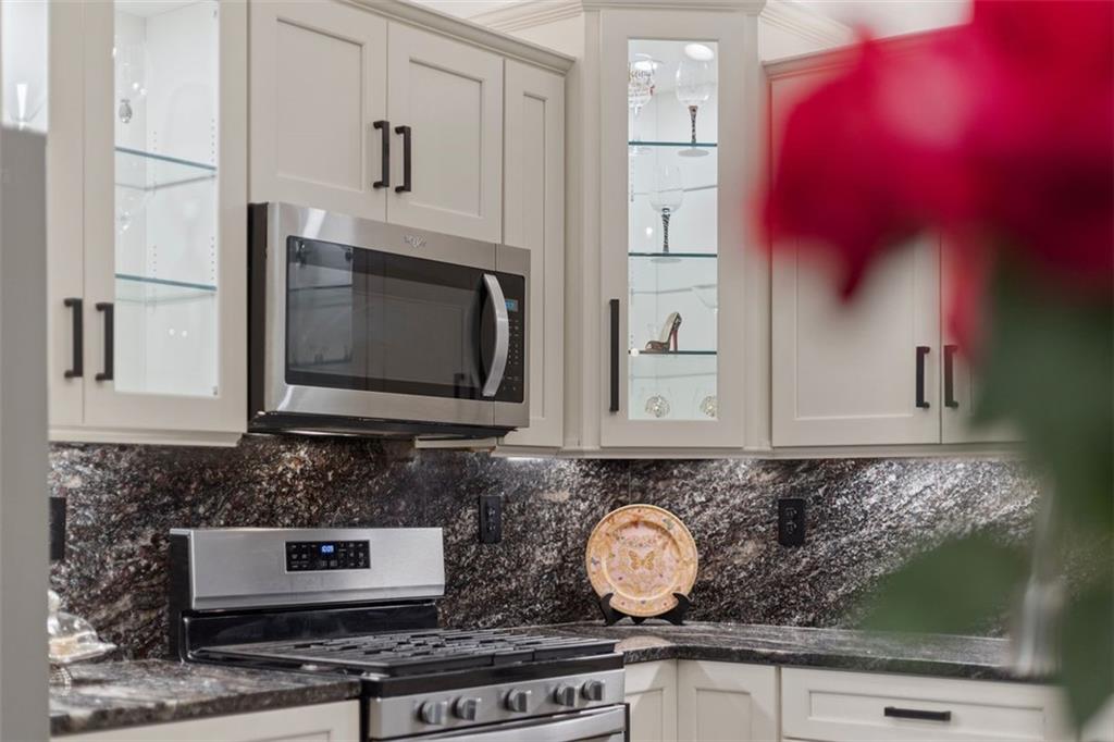 113 Hemingway Lane Coraopolis, PA 15108 - Photo 14 of 44 a kitchen with stainless steel appliances granite countertop a stove a microwave and cabinets