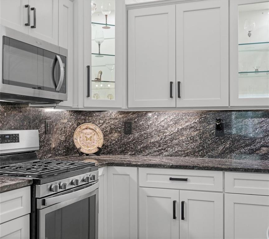 113 Hemingway Lane Coraopolis, PA 15108 - Photo 16 of 44 a kitchen with granite countertop white cabinets and stainless steel appliances