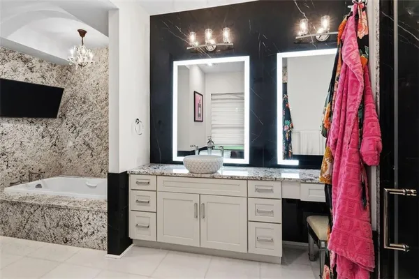 a bathroom with a bathtub sink and mirror