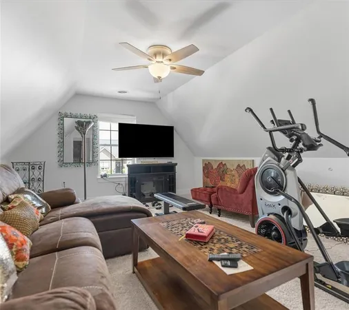 a living room with furniture a flat screen tv and a chandelier