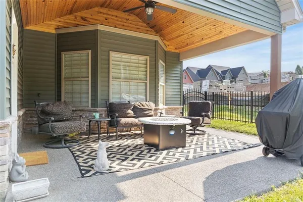a view of a patio with couches chairs and a potted plant