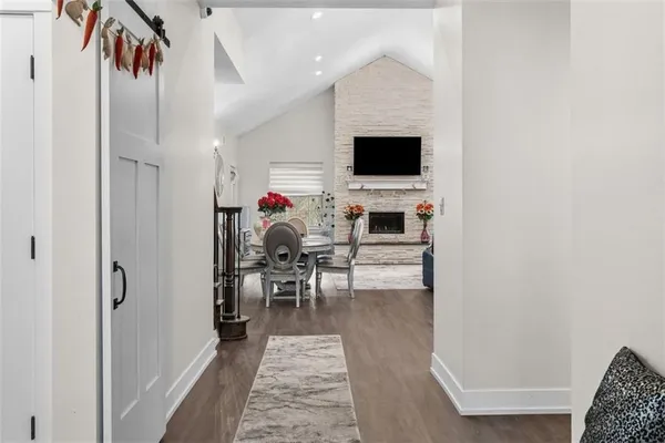 a view of a livingroom with furniture and a flat screen tv