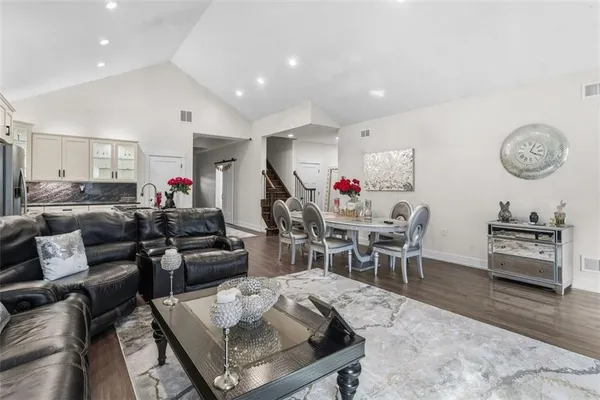 a living room with furniture a clock and a table