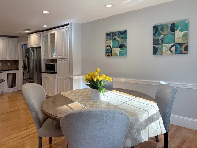 a bedroom with a bed furniture and a large mirror