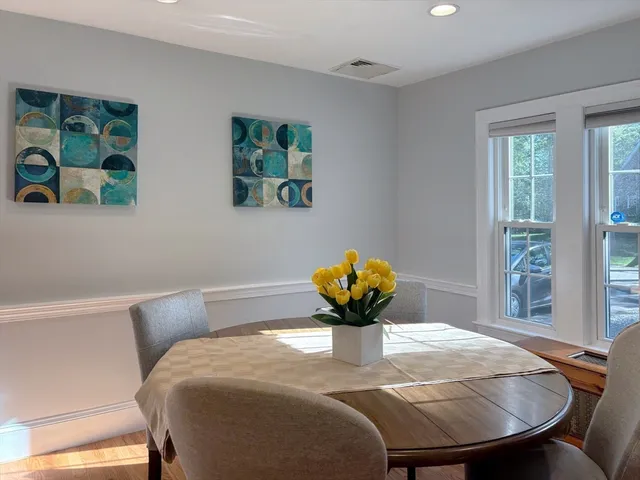 a dining room with furniture and window
