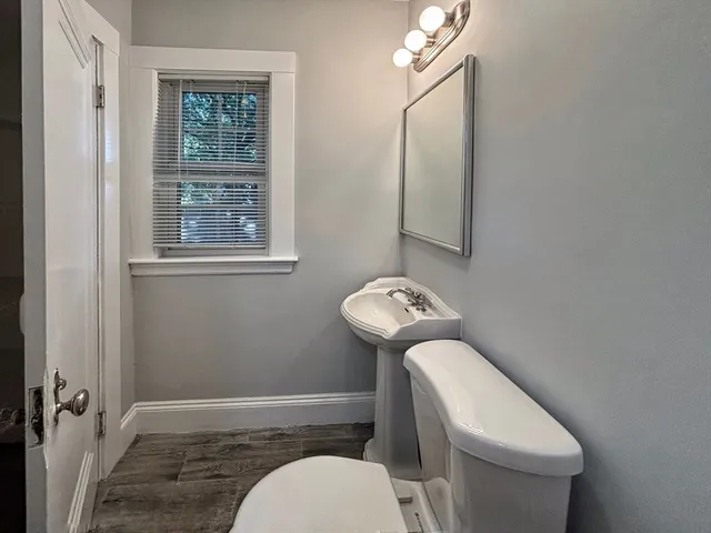 a white toilet sitting next to a bathroom sink