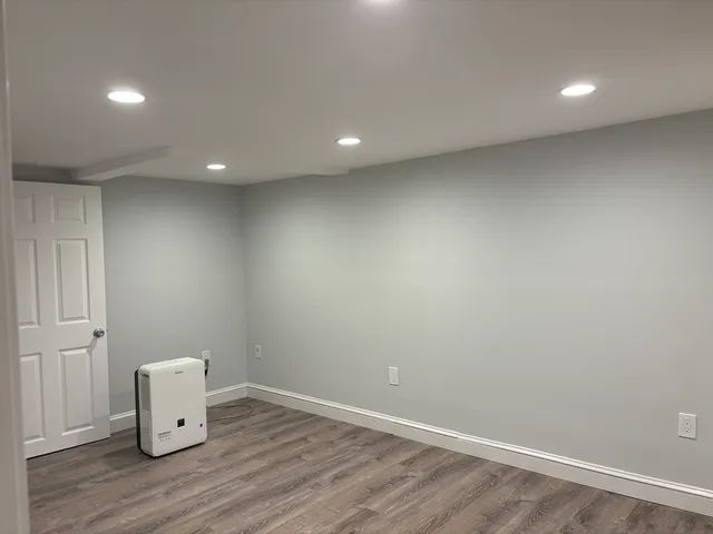 an empty room with wooden floor