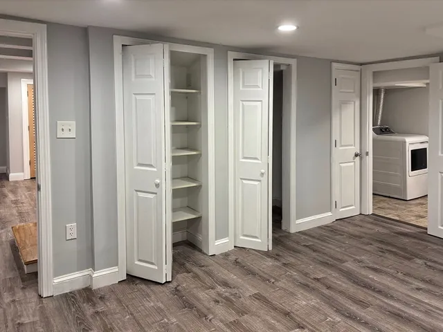 an empty room with closet and wooden floor