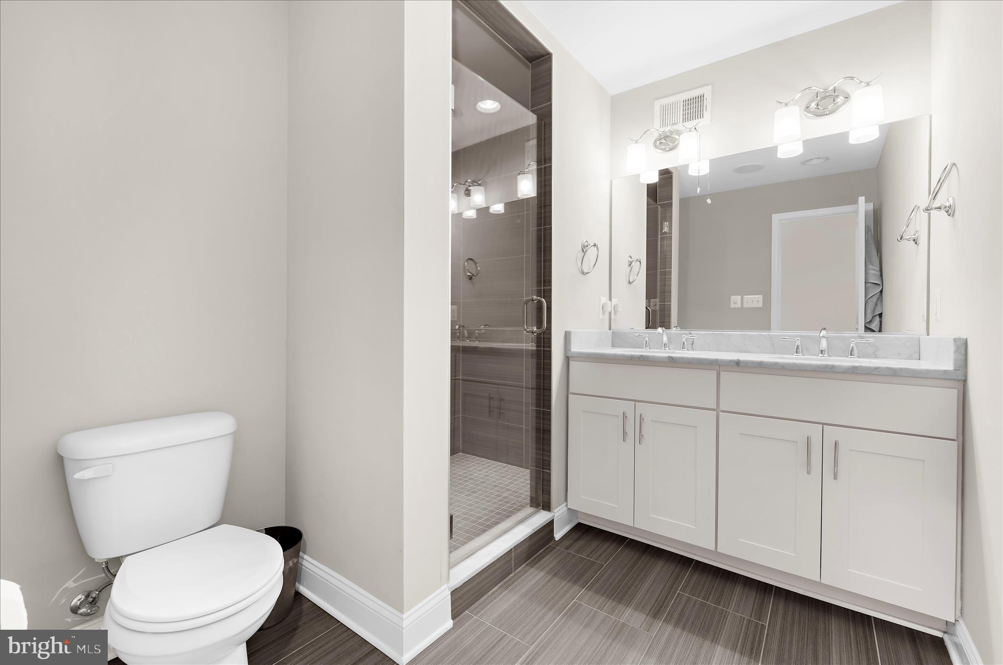 932 South Clinton Street Baltimore, MD 21224 - Photo 16 of 46 a bathroom with a toilet a sink and mirror