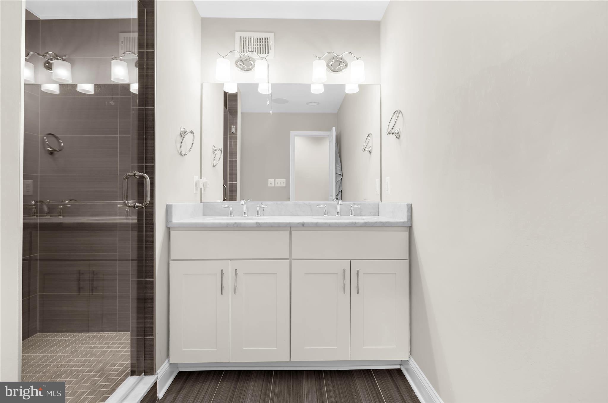 932 South Clinton Street Baltimore, MD 21224 - Photo 19 of 46 a bathroom with a sink vanity and a mirror