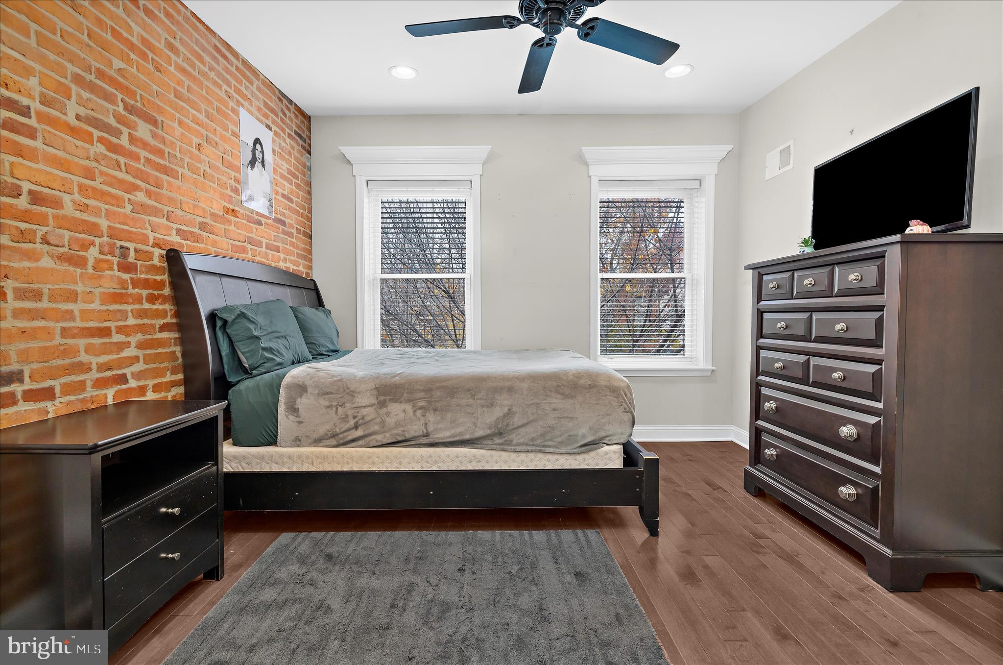 932 South Clinton Street Baltimore, MD 21224 - Photo 20 of 46 a bedroom with a bed and a flat screen tv