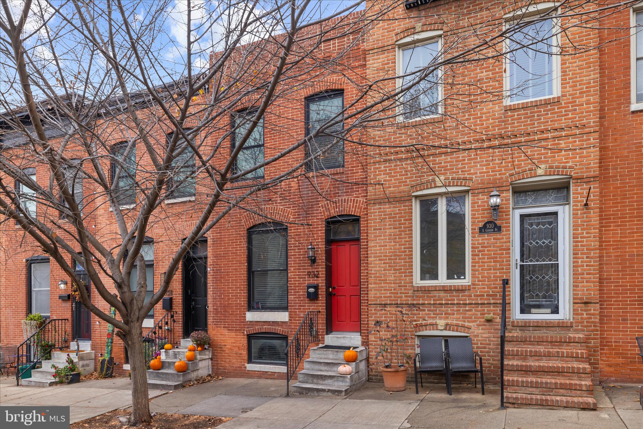 932 South Clinton Street Baltimore, MD 21224 - Photo 2 of 46 a front view of a building with large trees