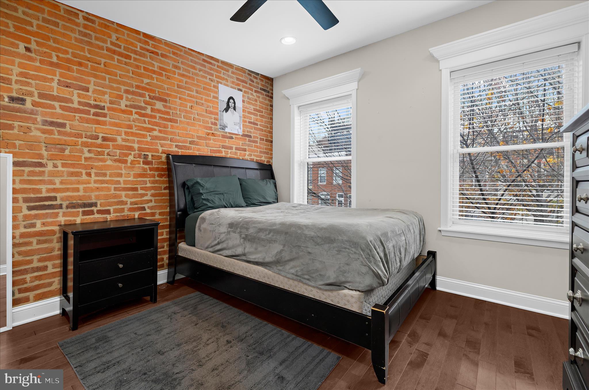 932 South Clinton Street Baltimore, MD 21224 - Photo 21 of 46 a bedroom with a bed and a flat tv screen