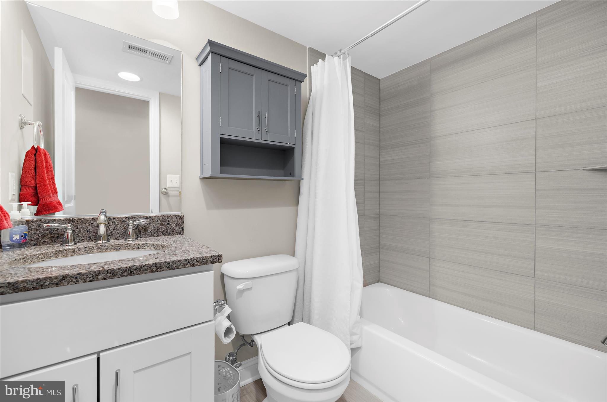 932 South Clinton Street Baltimore, MD 21224 - Photo 28 of 46 a bathroom with a granite countertop bathtub shower sink vanity and toilet