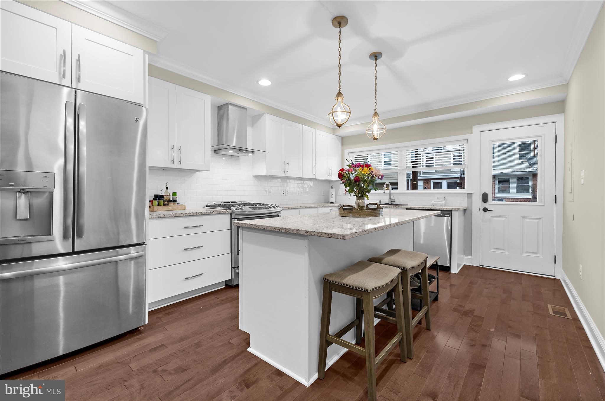 932 South Clinton Street Baltimore, MD 21224 - Photo 10 of 46 a kitchen with kitchen island white cabinets and stainless steel appliances