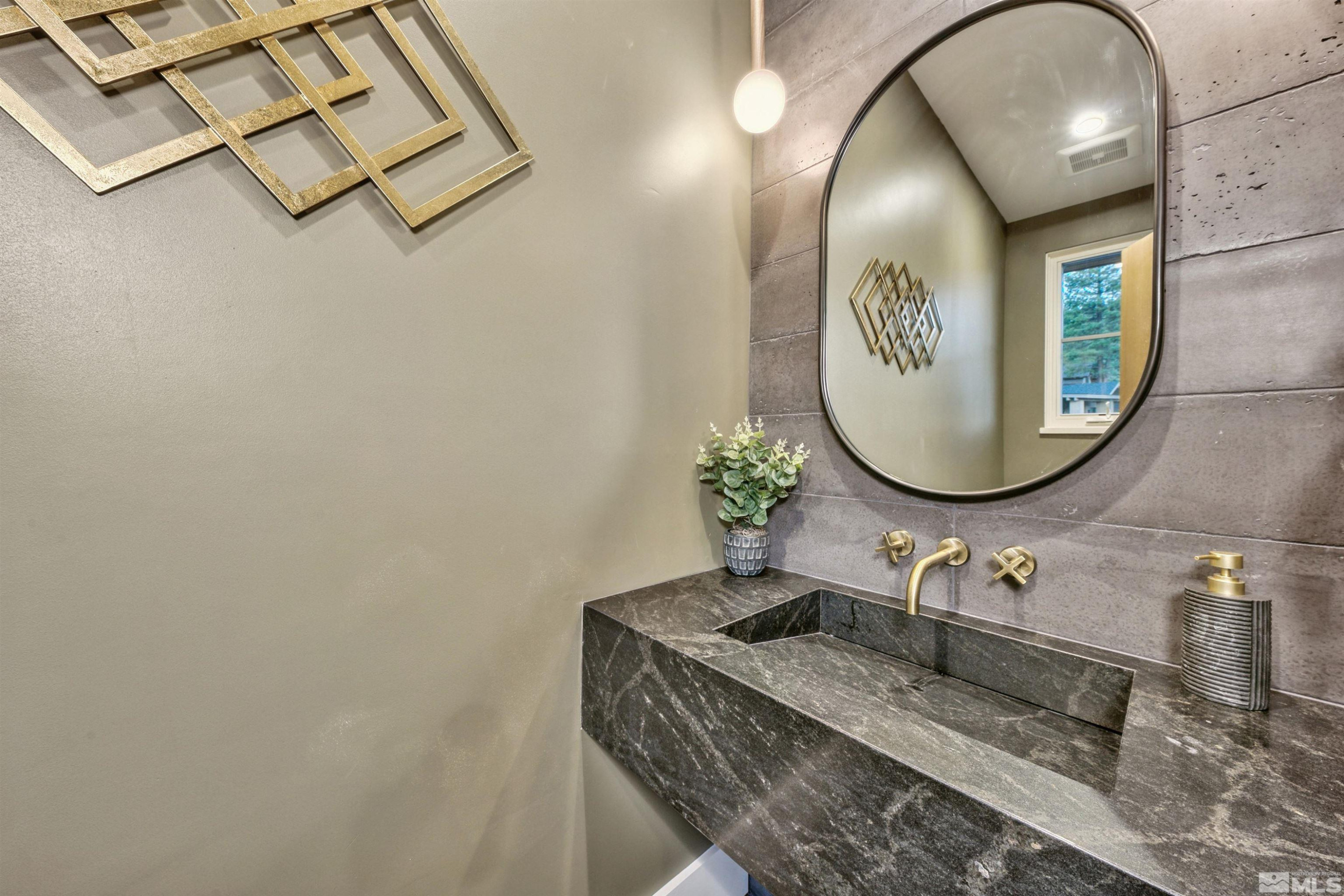 265 Mill Race Loop Carson City, NV 89705 - Photo 19 of 40 a bathroom with a granite countertop sink and mirror