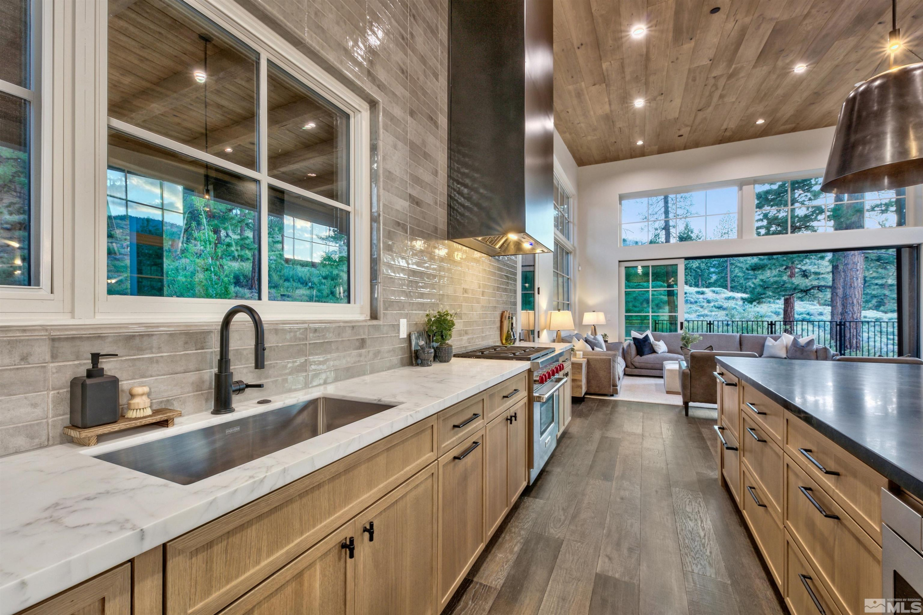 265 Mill Race Loop Carson City, NV 89705 - Photo 5 of 40 a large kitchen with stainless steel appliances a sink a counter space and a large window
