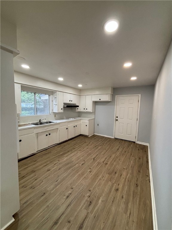 4130 Up River Road Corpus Christi, TX 78408 - Photo 2 of 7 a large kitchen with a stove a sink dishwasher a refrigerator and white cabinets with wooden floor