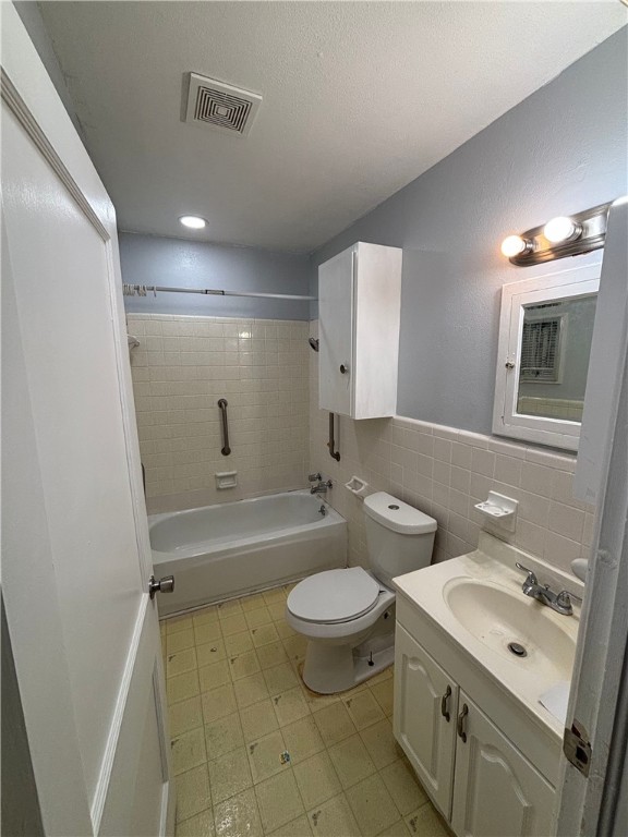 4130 Up River Road Corpus Christi, TX 78408 - Photo 3 of 7 a bathroom with a double vanity sink toilet mirror and bathtub