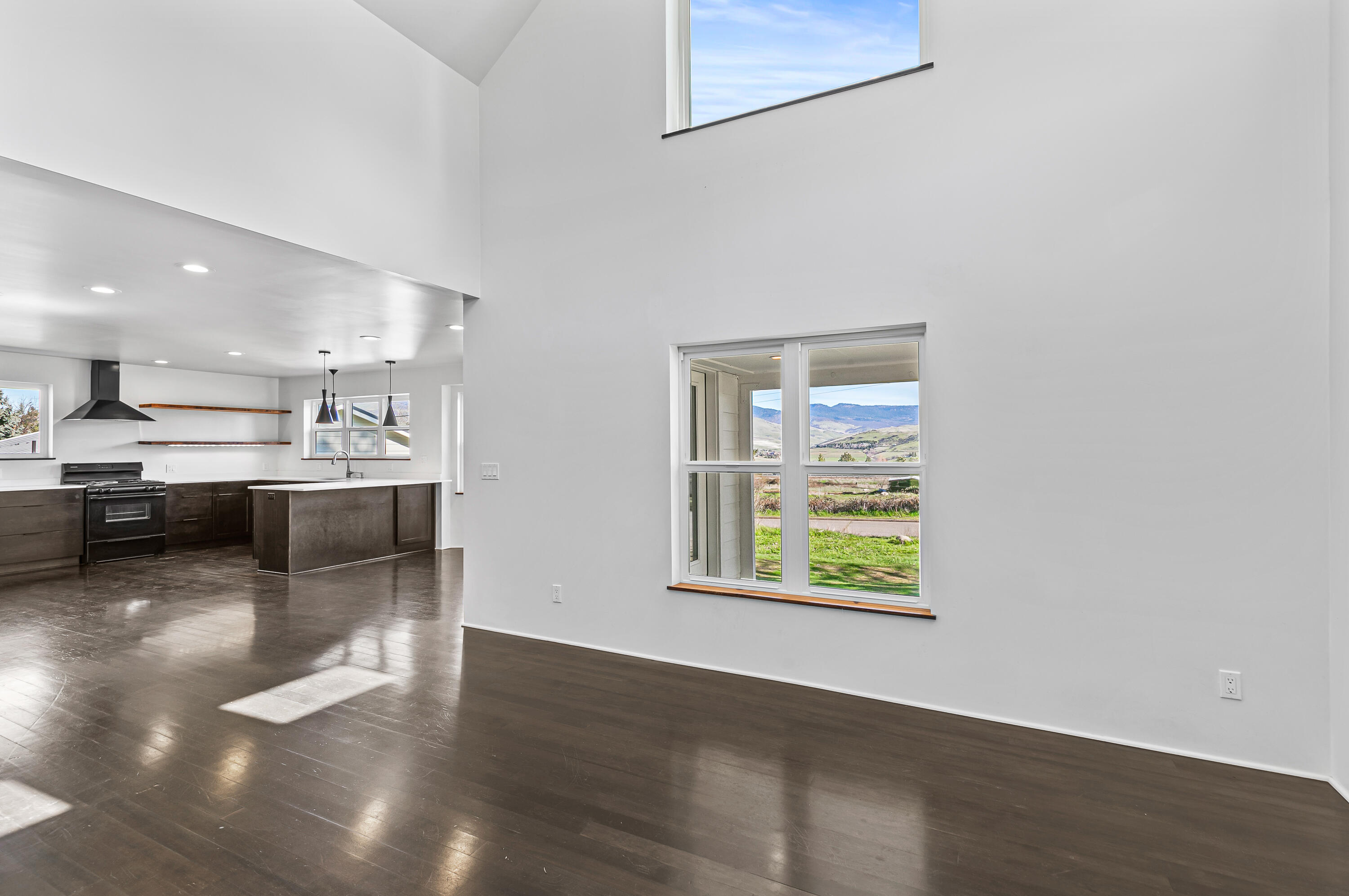 593 Crowson Road Ashland, OR 97520 - Photo 3 of 36 a kitchen with stainless steel appliances kitchen island hardwood floor sink and stove