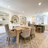 a dining room with a table and chairs