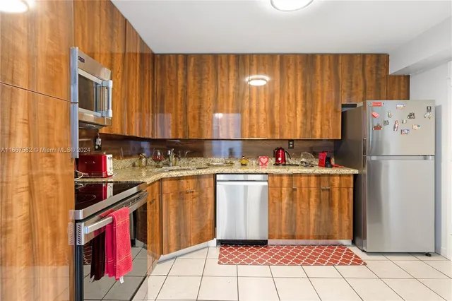 a kitchen with stainless steel appliances a refrigerator sink and cabinets
