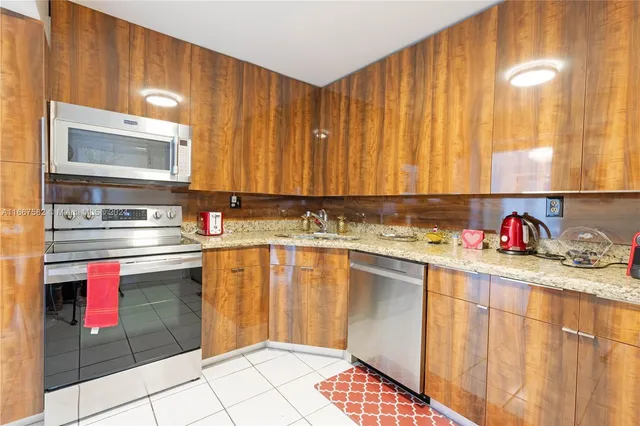 a kitchen with stainless steel appliances cabinets a sink and a counter top space