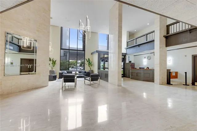 a view of a hallway with wooden floor and windows
