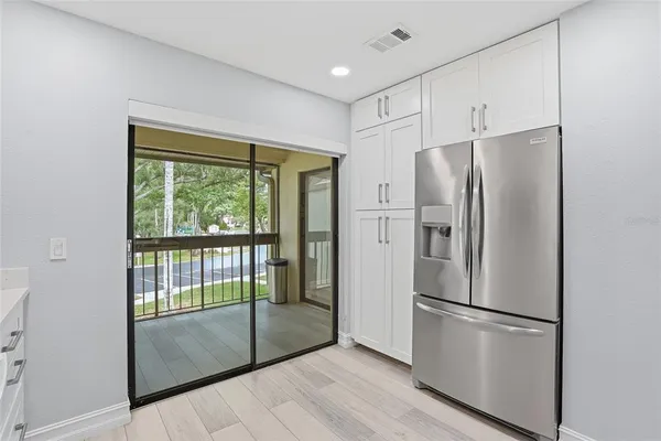 a kitchen with stainless steel appliances a refrigerator sink and cabinets