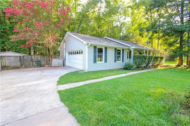 a front view of house with yard and green space