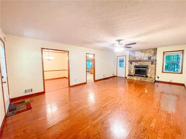 wooden floor fireplace and natural light in room