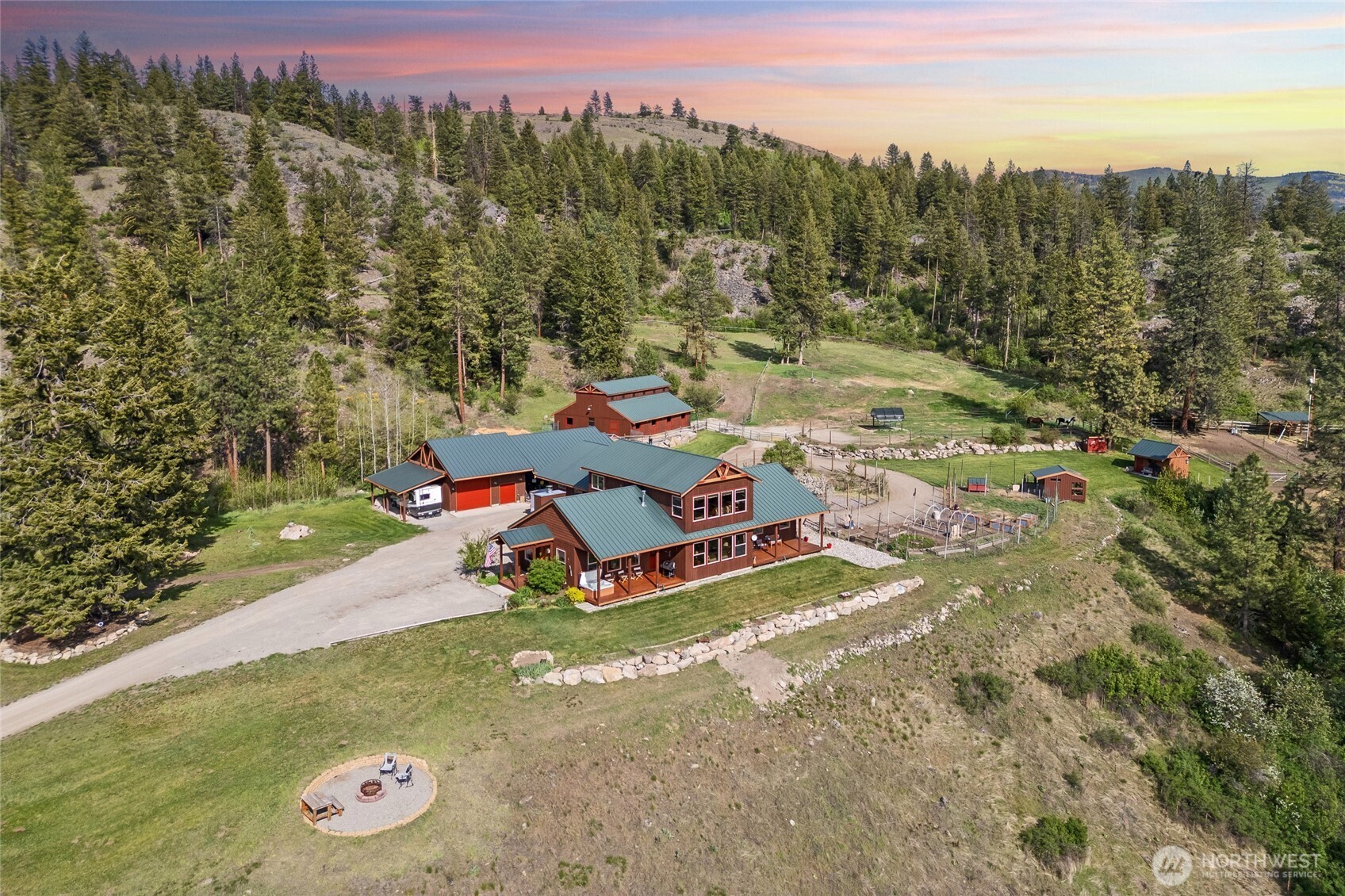a view of a childrens park with large trees