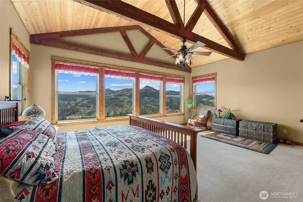 a bed sitting in a bedroom next to a window