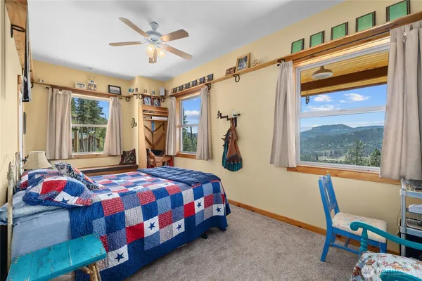 a bedroom with a bed a window and dresser