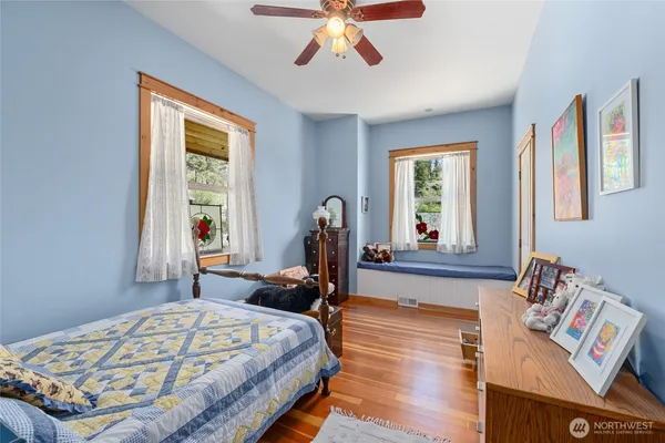 a bed sitting in a bedroom next to a window