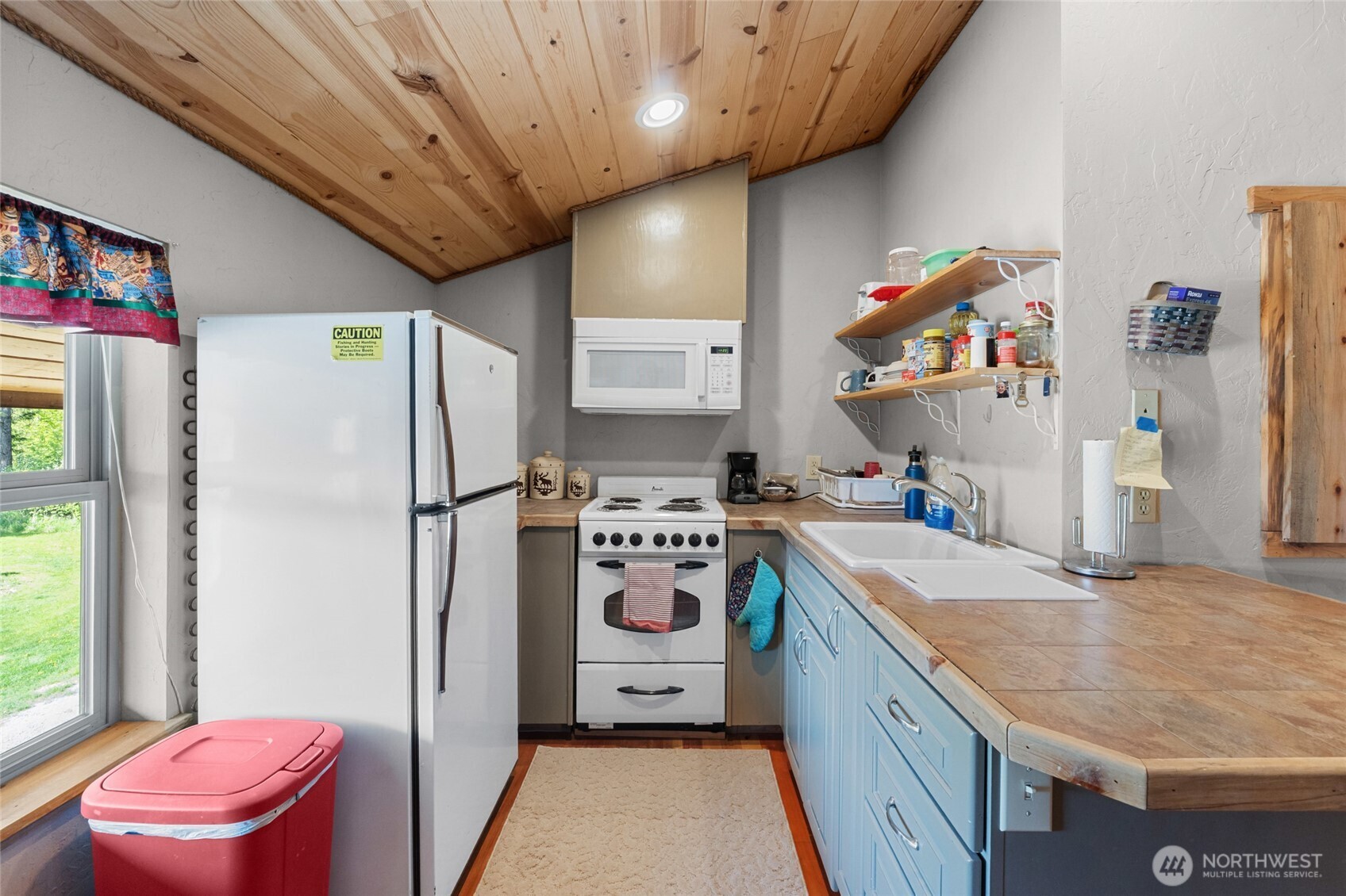 40 Happy Jack Road Curlew, WA 99118 - Photo 24 of 40 a kitchen with a refrigerator a stove a washer and dryer