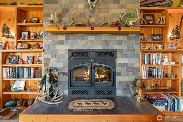 a living room with fireplace furniture and a book shelf