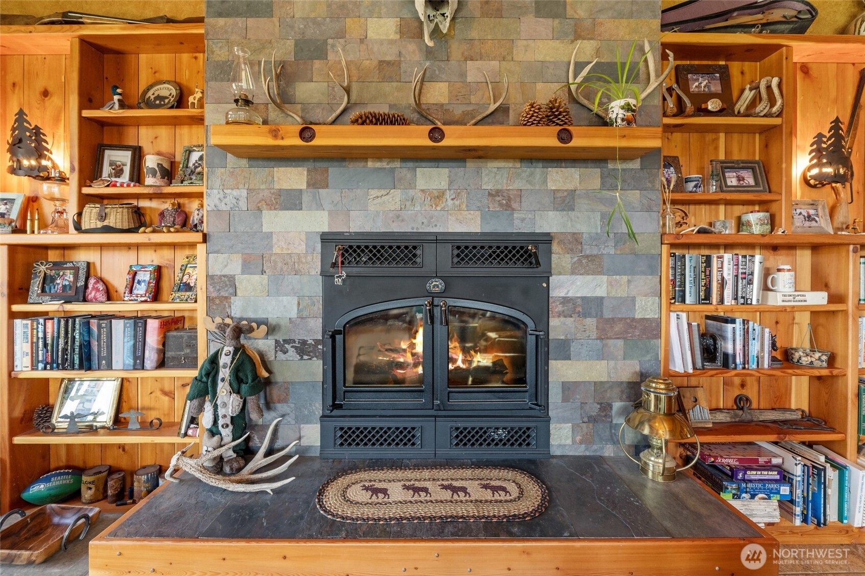40 Happy Jack Road Curlew, WA 99118 - Photo 8 of 40 a living room with fireplace furniture and a book shelf