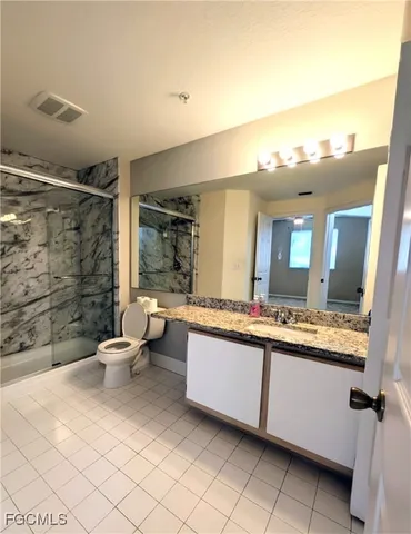 a bathroom with a sink mirror and toilet