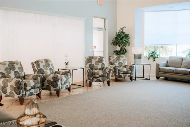 a living room with furniture and potted plants