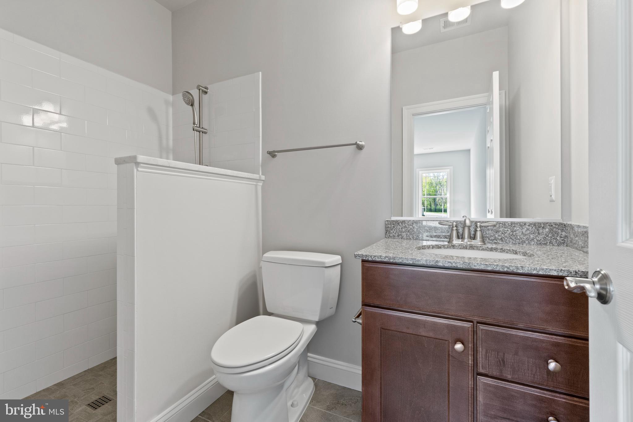 13725 Orlando Road Nokesville, VA 20181 - Photo 50 of 65 a bathroom with a granite countertop toilet sink and mirror