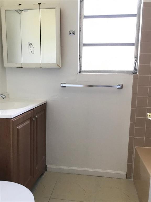 8031 Lagos De Campo Boulevard, Unit L3 Tamarac, FL 33321 - Photo 12 of 26 a bathroom with a sink and a vanity