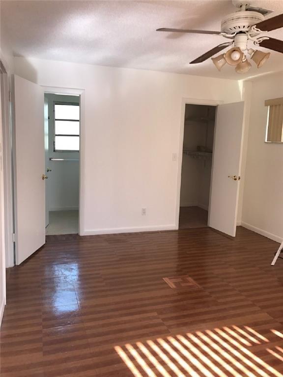 8031 Lagos De Campo Boulevard, Unit L3 Tamarac, FL 33321 - Photo 13 of 26 a view of room with window and wooden floor